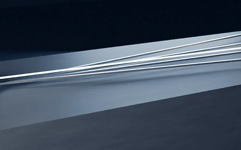 Light signals routed across a table toward a warm lamp