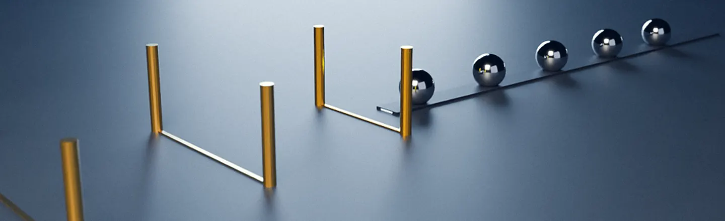 Brass gates along a track, a few steel spheres passing through