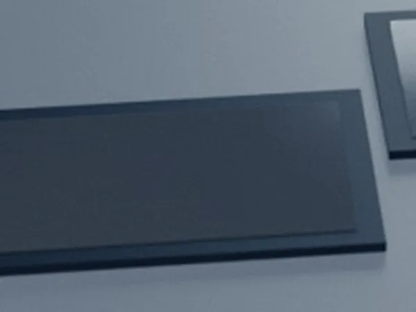 A frame half lit on a dark table